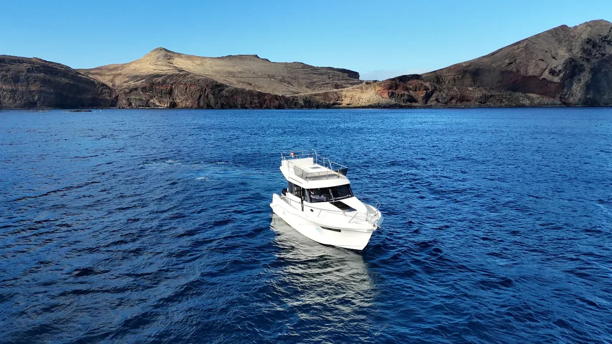 Madeira Charter vessel cruising beside Madeira's coast