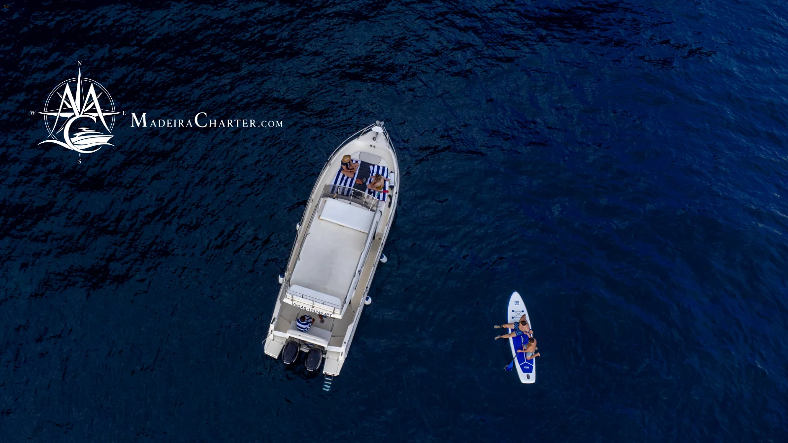Aerial view of a private boat with paddleboard