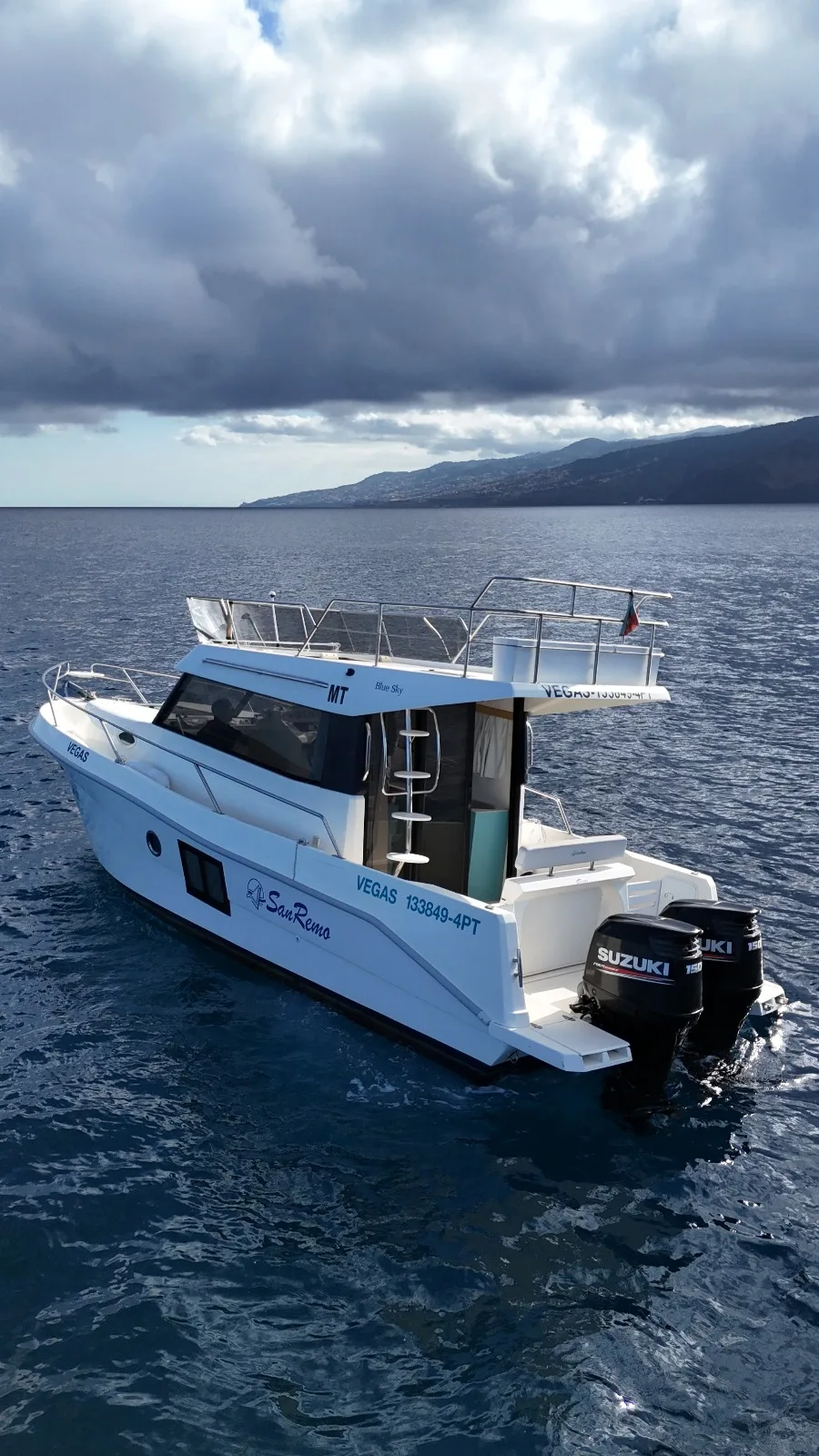 Elevated view of the Madeira Charter vessel beside the coast